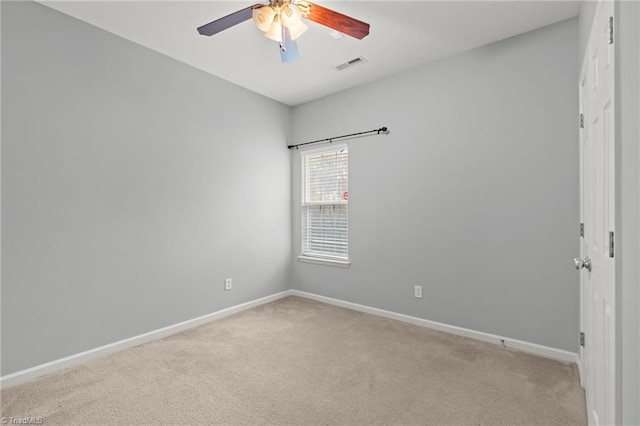 carpeted spare room featuring ceiling fan