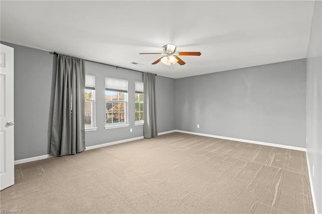 carpeted spare room with ceiling fan