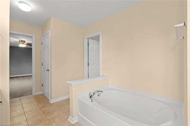 bathroom featuring tile patterned floors, ceiling fan, and a washtub