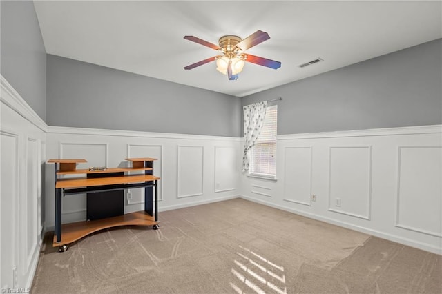 miscellaneous room with ceiling fan and light colored carpet