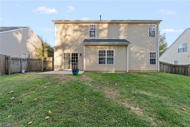 back of property with a patio area and a lawn