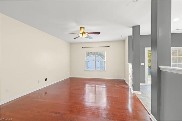 empty room with ceiling fan and hardwood / wood-style flooring