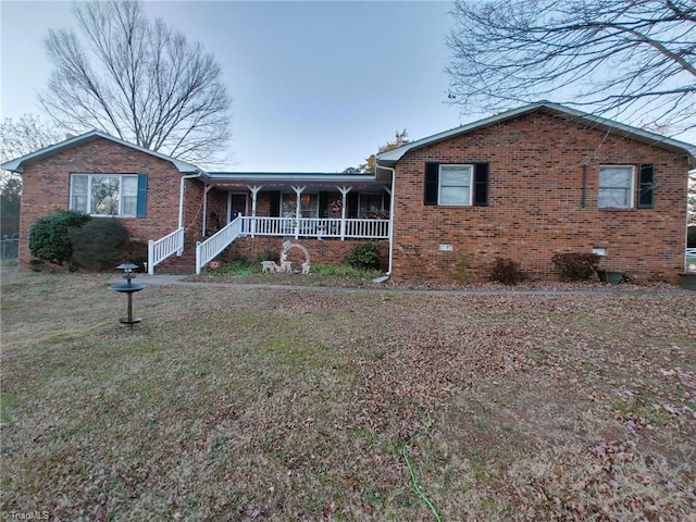 single story home featuring covered porch