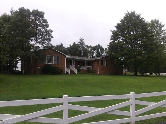 view of front of property with covered porch and a front yard