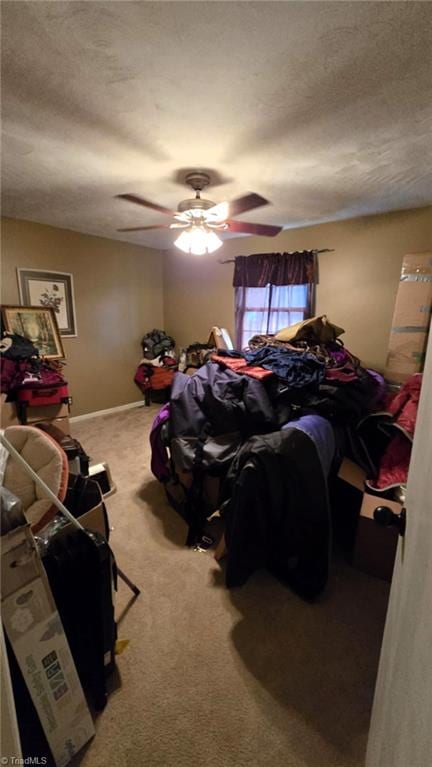 bedroom with ceiling fan, a textured ceiling, and carpet floors