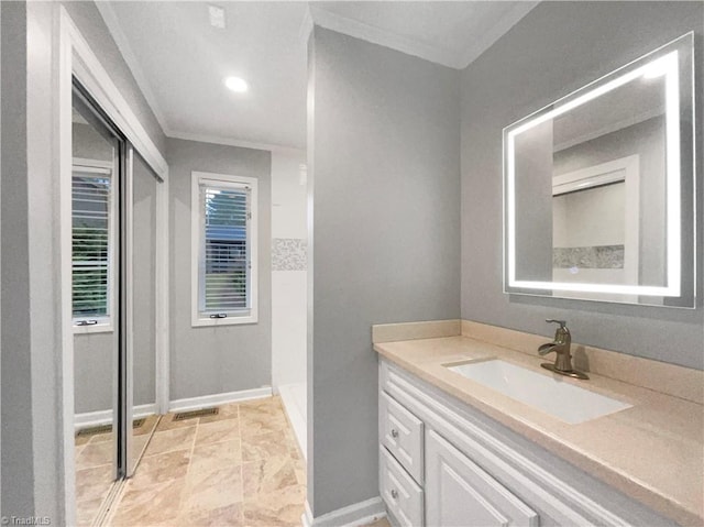 bathroom with visible vents, vanity, baseboards, and ornamental molding