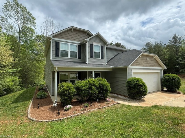 view of front facade with a front lawn, driveway, and a garage