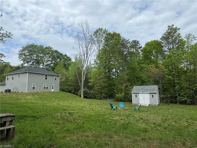 view of yard with central AC, an outdoor structure, and a storage shed