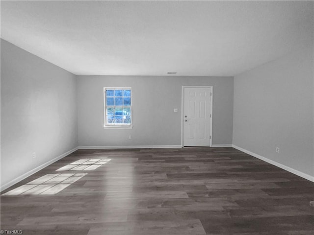 empty room with dark wood-type flooring