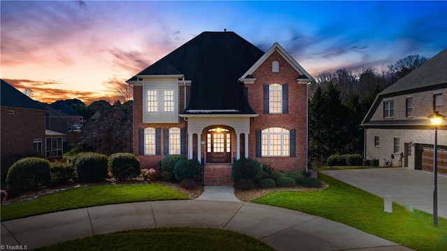 view of front property with french doors, a yard, and a garage