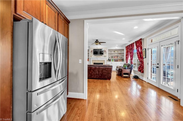 kitchen with stainless steel refrigerator with ice dispenser, french doors, ornamental molding, built in shelves, and ceiling fan