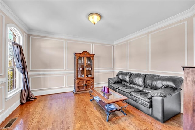 living room with crown molding, plenty of natural light, and wood-type flooring