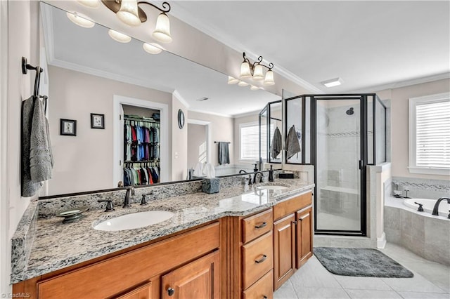 bathroom featuring tile patterned floors, vanity, crown molding, and independent shower and bath