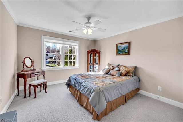 carpeted bedroom featuring ceiling fan and crown molding