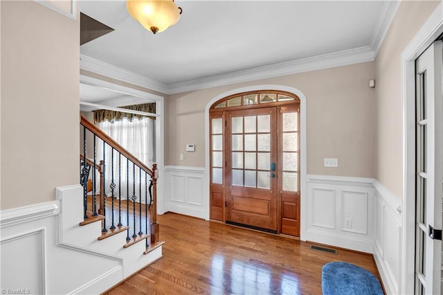 entryway featuring hardwood / wood-style floors and ornamental molding