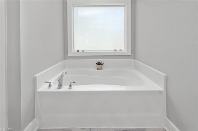 bathroom with a garden tub