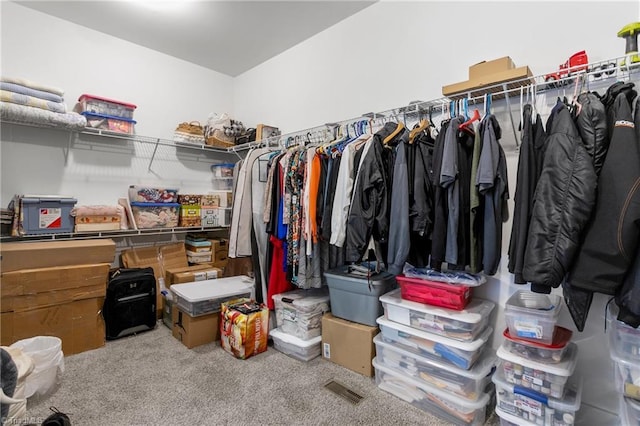 walk in closet with visible vents and carpet