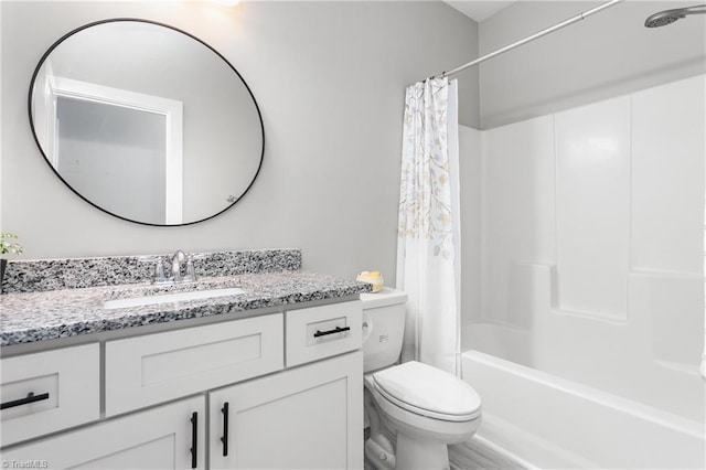 bathroom with vanity, shower / bath combo, and toilet
