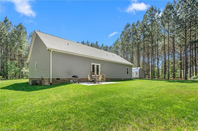 back of property featuring french doors, central AC unit, a patio area, entry steps, and a yard