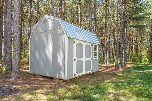 view of shed with a forest view