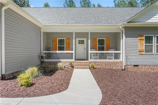 property entrance with a porch, roof with shingles, and crawl space