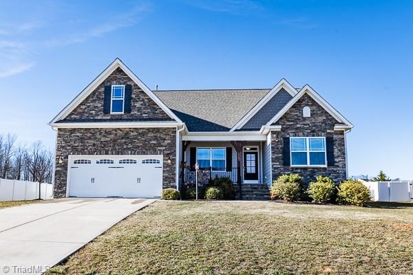 craftsman inspired home with a front lawn