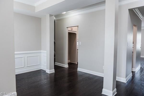 unfurnished room with dark hardwood / wood-style flooring and ornamental molding