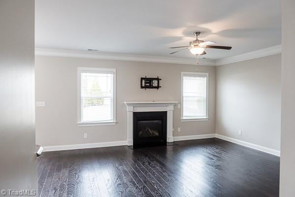 unfurnished living room with ceiling fan, ornamental molding, and dark hardwood / wood-style flooring