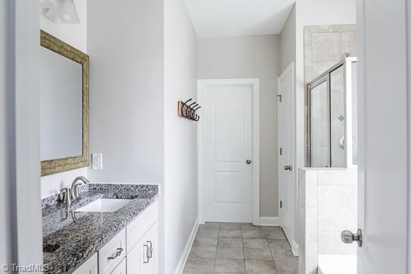 bathroom featuring vanity and a tile shower