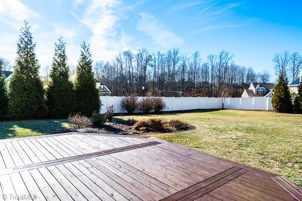 wooden terrace featuring a yard