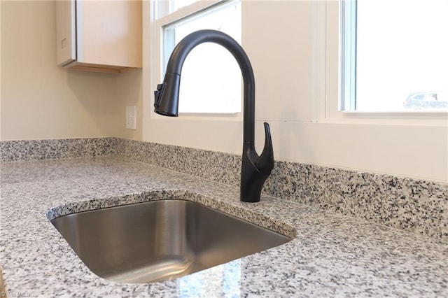 details with light stone countertops and sink