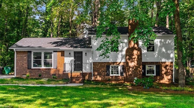 1710 Scarborough Rd, High Point, NC 27265 - split level home with a front yard, brick siding, and a chimney