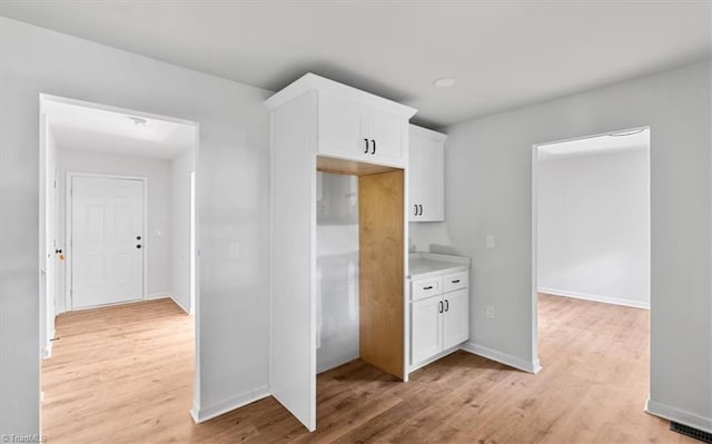 1710 Scarborough Rd, High Point, NC 27265 - kitchen featuring white cabinetry, light wood-type flooring, and light countertops