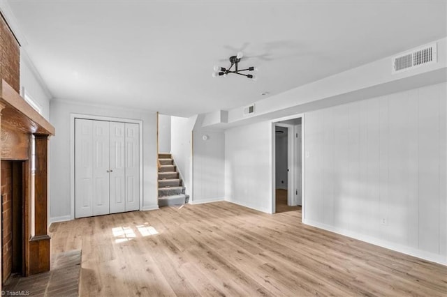 1710 Scarborough Rd, High Point, NC 27265 - unfurnished living room with stairway and wood finished floors