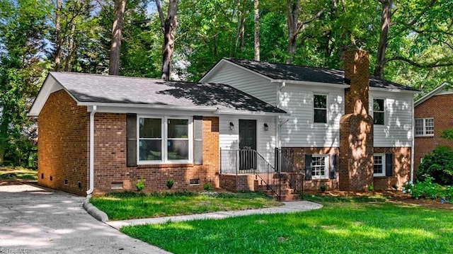 1710 Scarborough Rd, High Point, NC 27265 - tri-level home featuring brick siding, a front lawn, crawl space, and a chimney