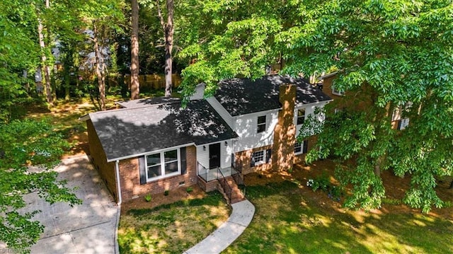 1710 Scarborough Rd, High Point, NC 27265 - view of front of house with a front yard, roof with shingles, brick siding, and concrete driveway