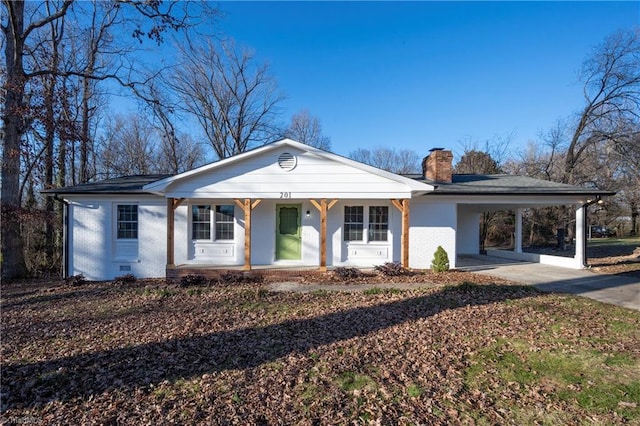 single story home featuring covered porch and a carport