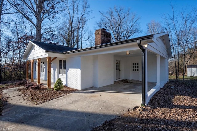 view of property exterior featuring a porch and a carport