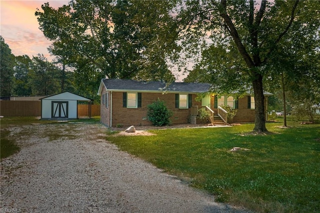5403 Southmont Dr, Julian, NC 27283 - single story home with a storage unit, gravel driveway, and brick siding