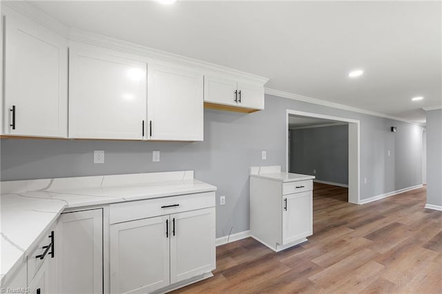 5403 Southmont Dr, Julian, NC 27283 - kitchen with ornamental molding, light stone counters, white cabinets, light wood finished floors, and recessed lighting