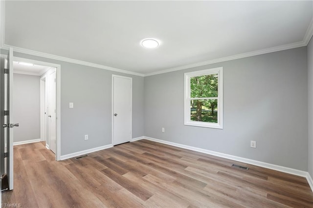 5403 Southmont Dr, Julian, NC 27283 - unfurnished bedroom featuring wood finished floors, crown molding, and a closet