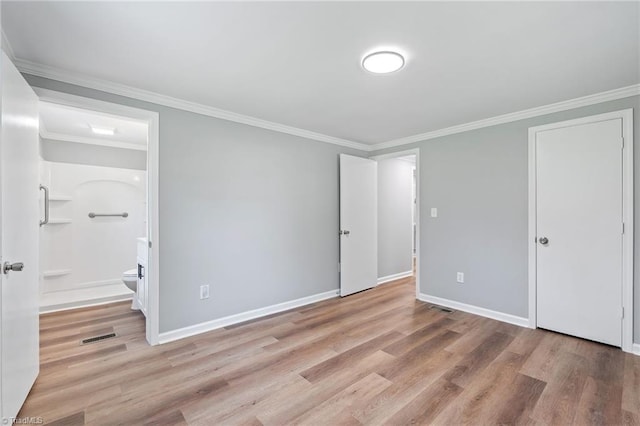 5403 Southmont Dr, Julian, NC 27283 - unfurnished bedroom with wood finished floors, ornamental molding, and connected bathroom