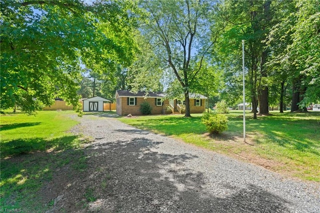 5403 Southmont Dr, Julian, NC 27283 - ranch-style home with a storage shed, a front lawn, and driveway