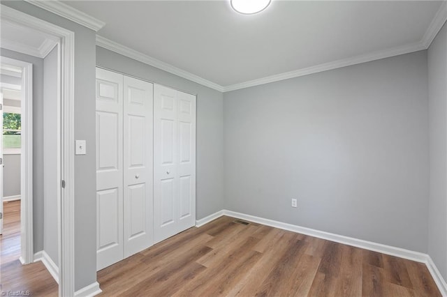 5403 Southmont Dr, Julian, NC 27283 - unfurnished bedroom featuring wood finished floors, a closet, and crown molding