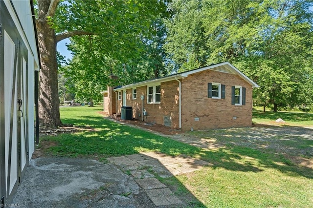 5403 Southmont Dr, Julian, NC 27283 - view of home's exterior with brick siding, a yard, a chimney, and crawl space