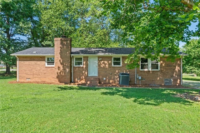 5403 Southmont Dr, Julian, NC 27283 - rear view of property featuring entry steps, a chimney, a lawn, brick siding, and crawl space