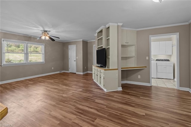unfurnished living room with washing machine and dryer, crown molding, wood finished floors, and ceiling fan