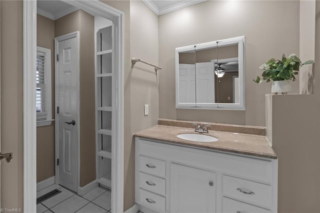 bathroom with vanity, visible vents, tile patterned flooring, and ornamental molding