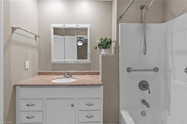 bathroom with ceiling fan, vanity, and washtub / shower combination