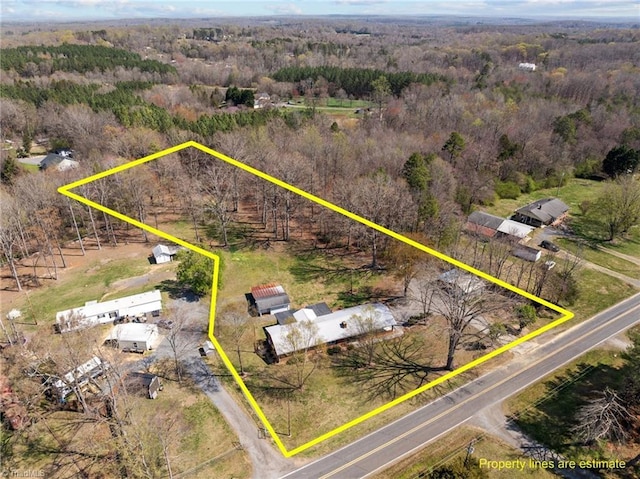 birds eye view of property with a wooded view